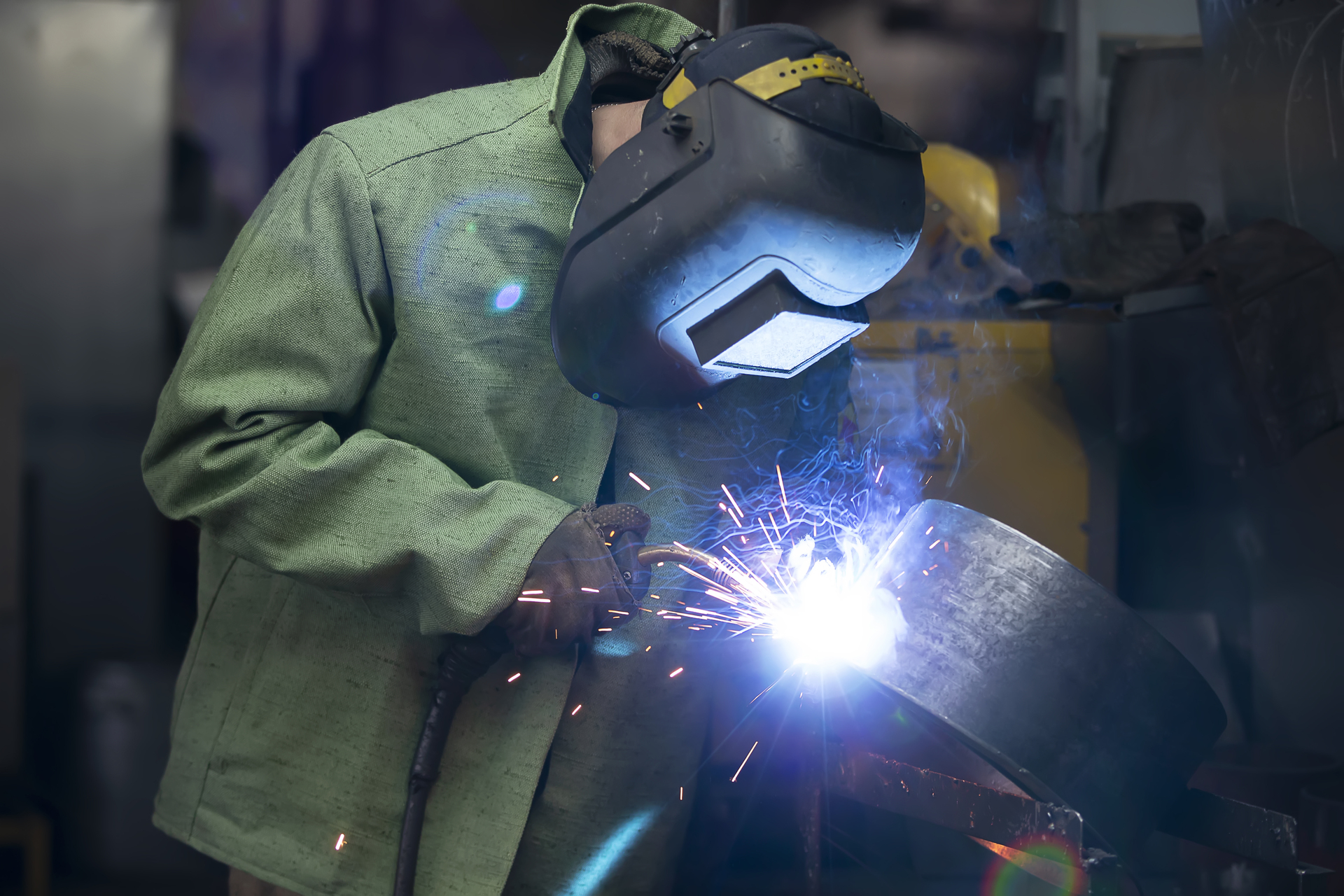 1920-a-welder-in-a-protective-helmet-welds-an-iron-seam.jpg