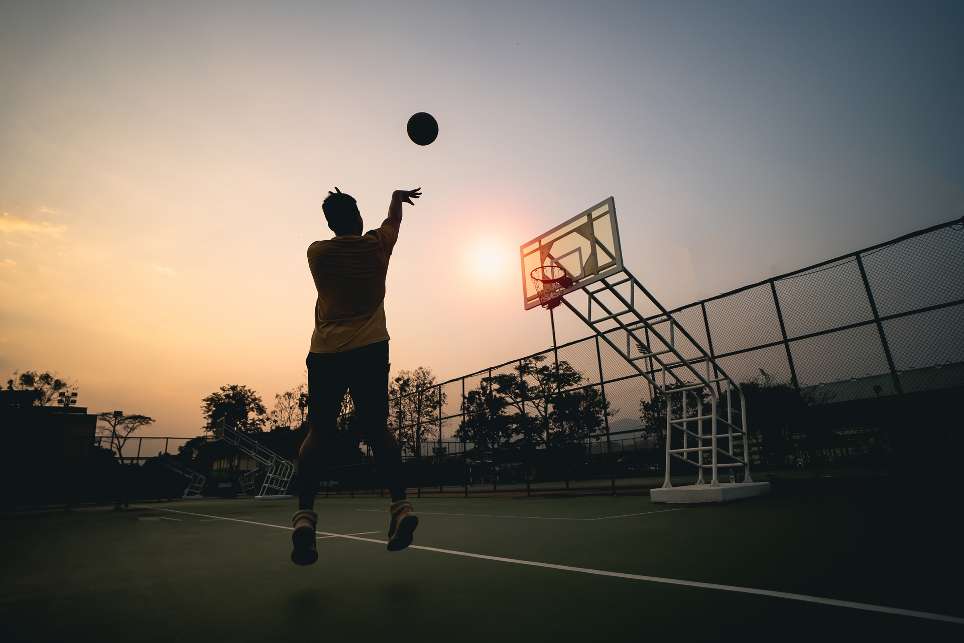 1920-basketball-player-silhouette-at-sunset-basketball-player-shoots-a-shot-sport-basketball-concept (1).jpg