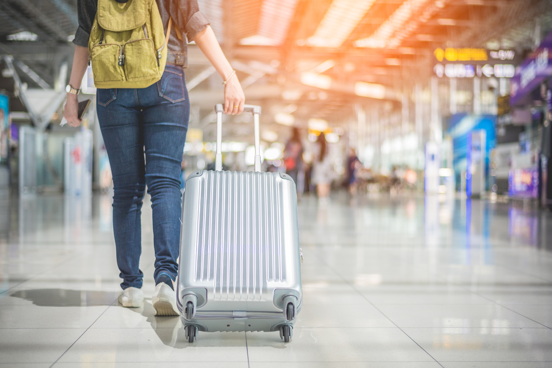 1920-beauty-asian-woman-traveling-and-holding-suitcase-in-the-airport.jpg