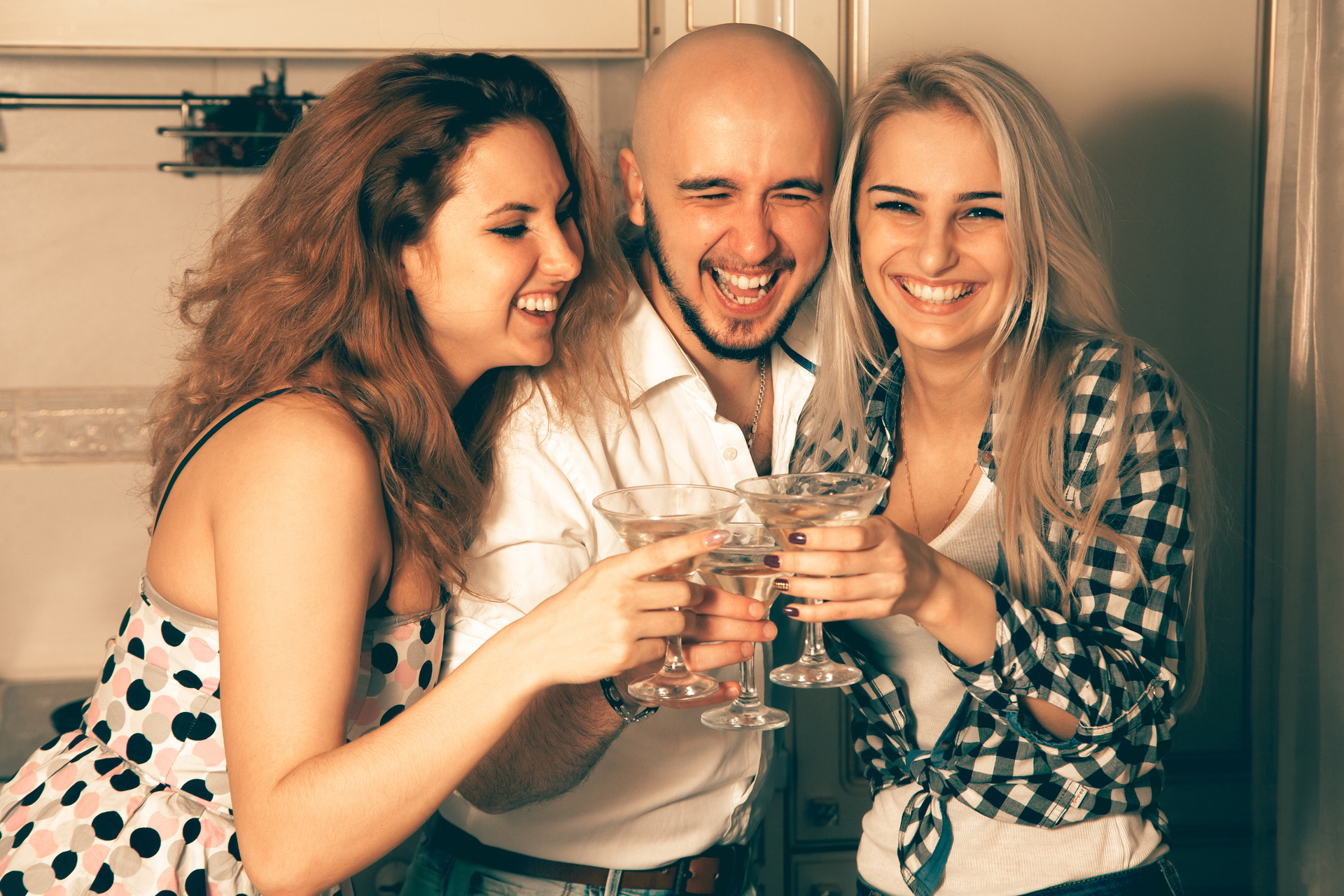 1920-couple-of-beautiful-ladies-having-fun-with-a-guy-at-a-party-with-a-glass-of-martini.jpg