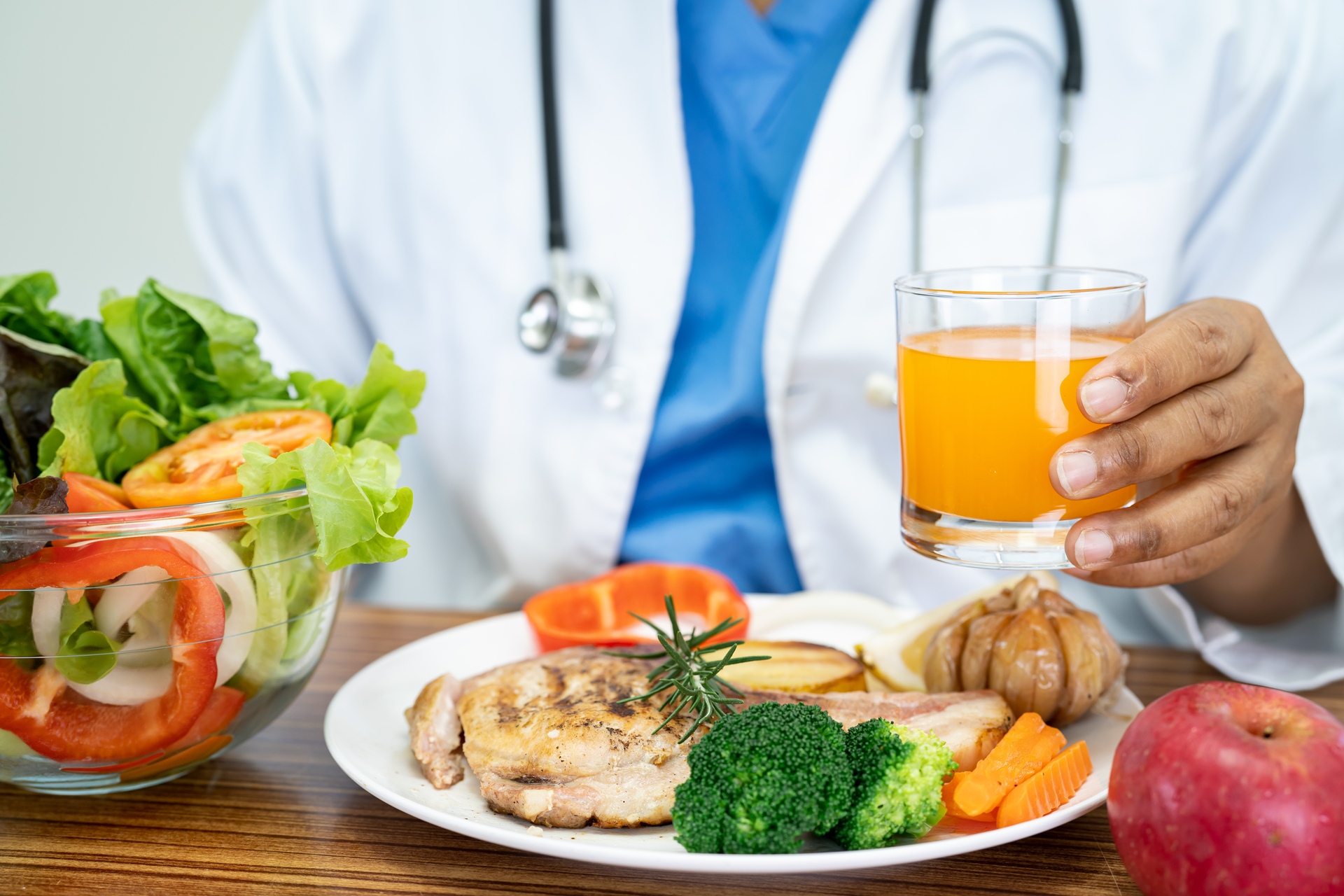 1920-nutritionist-doctor-with-various-healthy-fresh-vegetables-for-patient.jpg