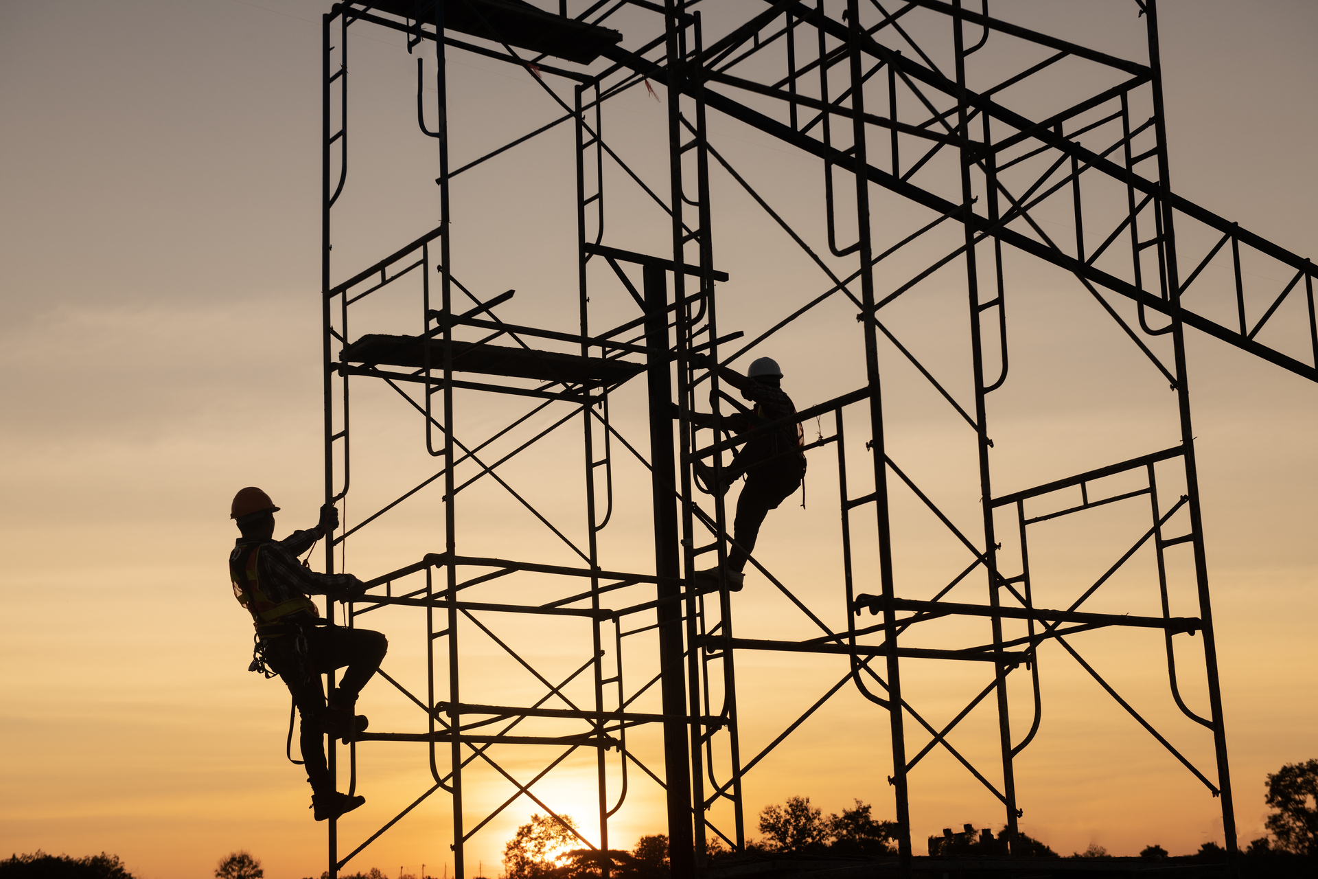 1920-teamwork-construction-worker-installation-scaffolding-in-industrial-construction-sunset-sky-background-overtime-job-silhouette.jpg