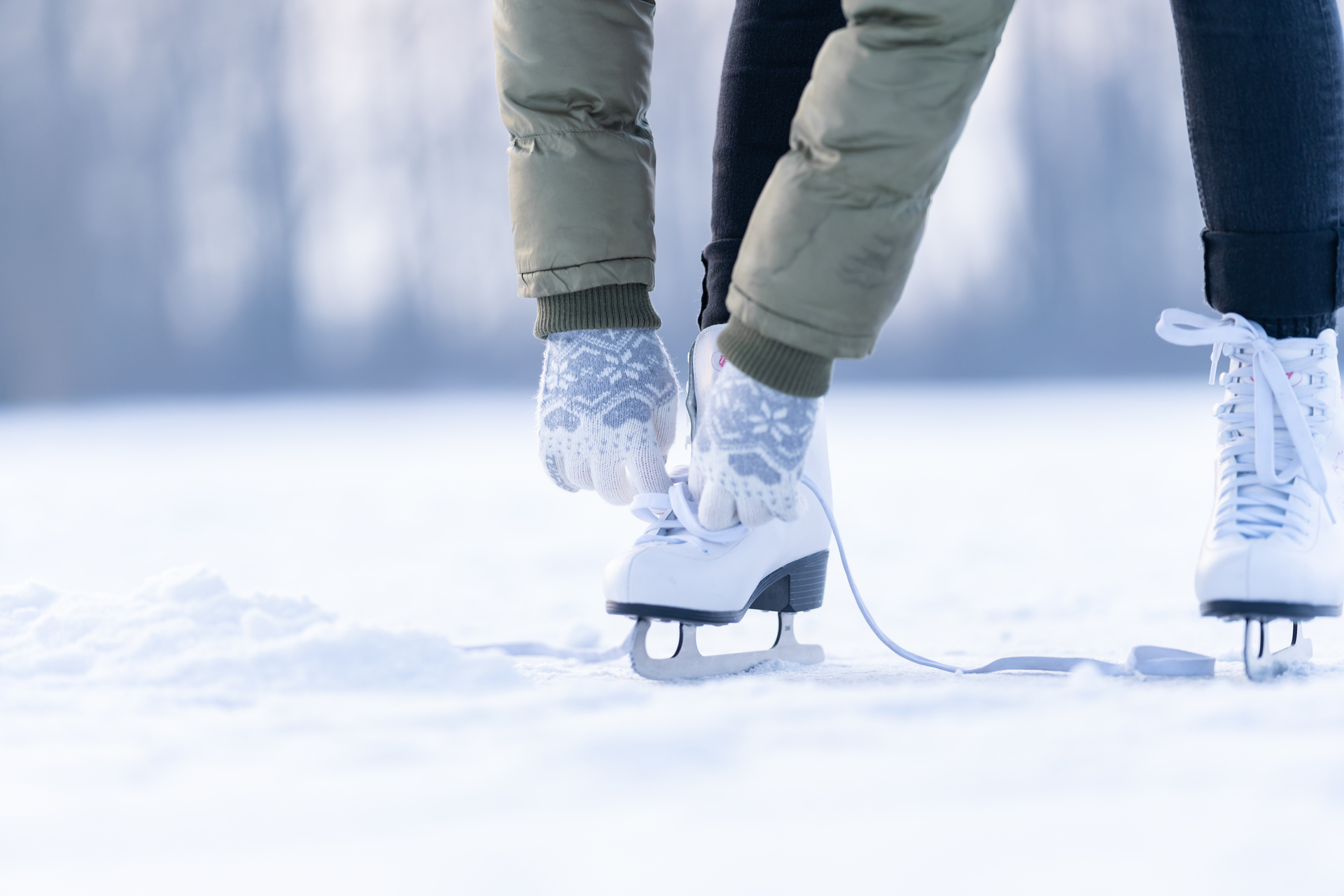 1920-tying-the-laces-of-winter-skates-on-a-frozen-lake-ice-skating.jpg